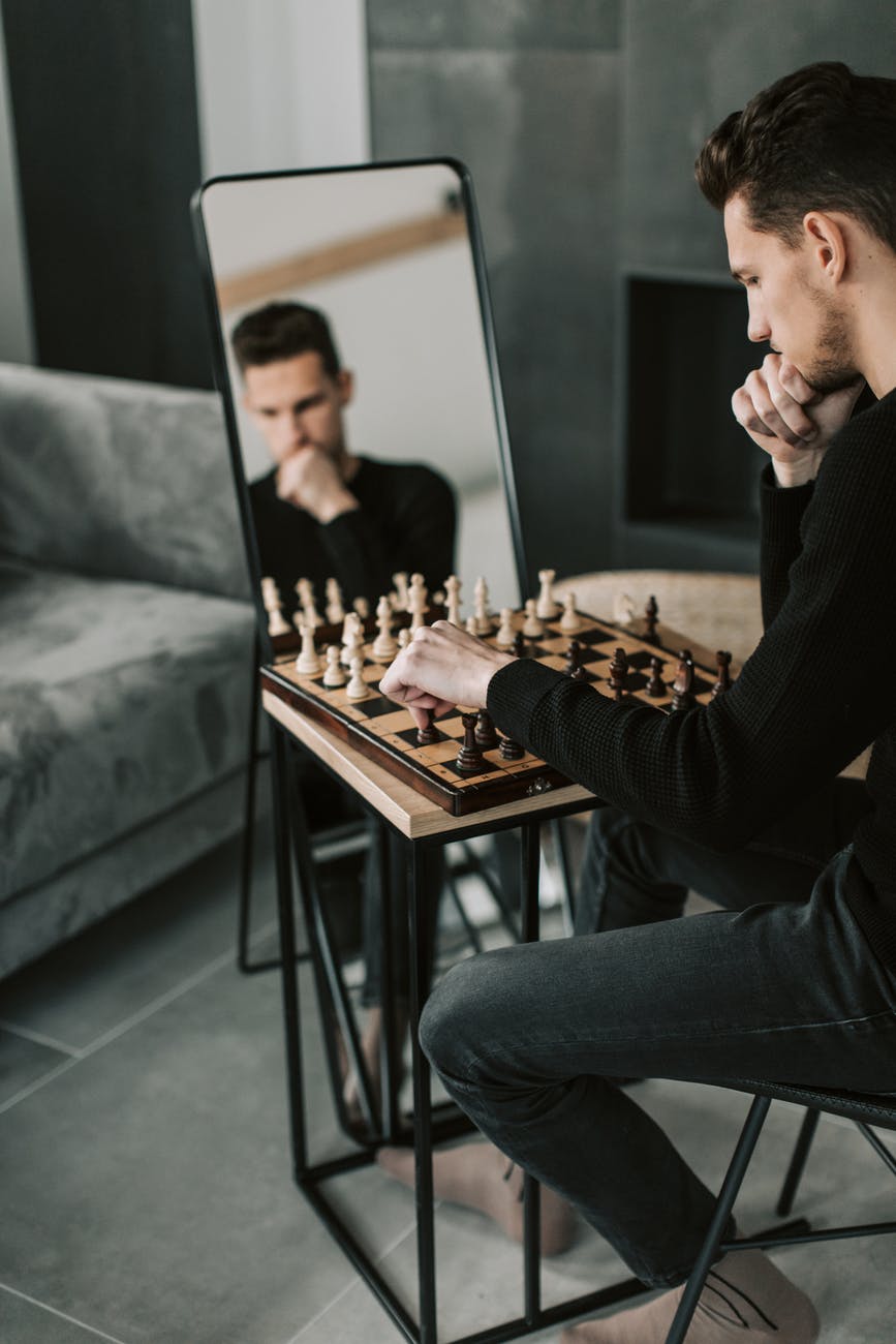 man in black long sleeve playing chess:More money through Strategic Internet Marketing