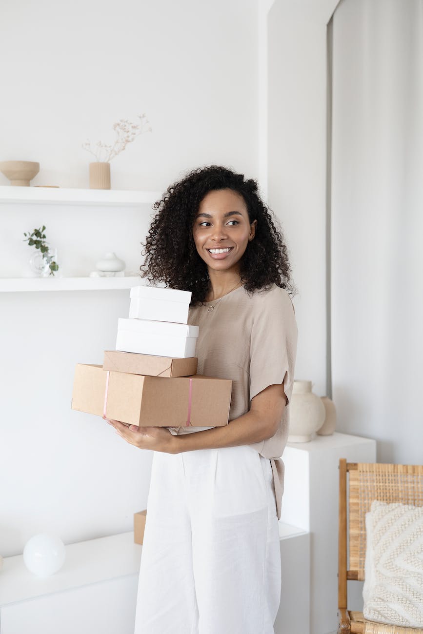 a woman holding cardboard boxes , affiliate program target