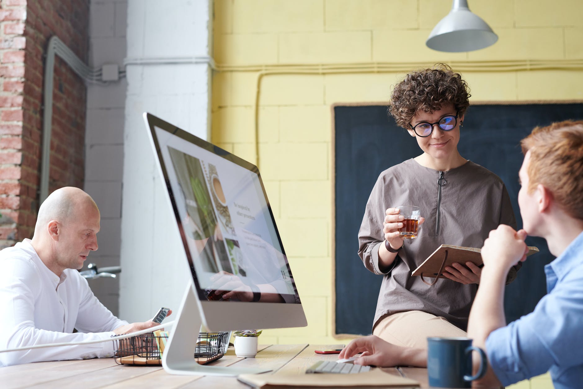 man in blue collared top using imac indoors 2023 business ideas