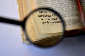 Magnifying glass on strategy text
